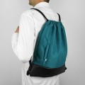 turquise backapck with black bottom drawstring bag